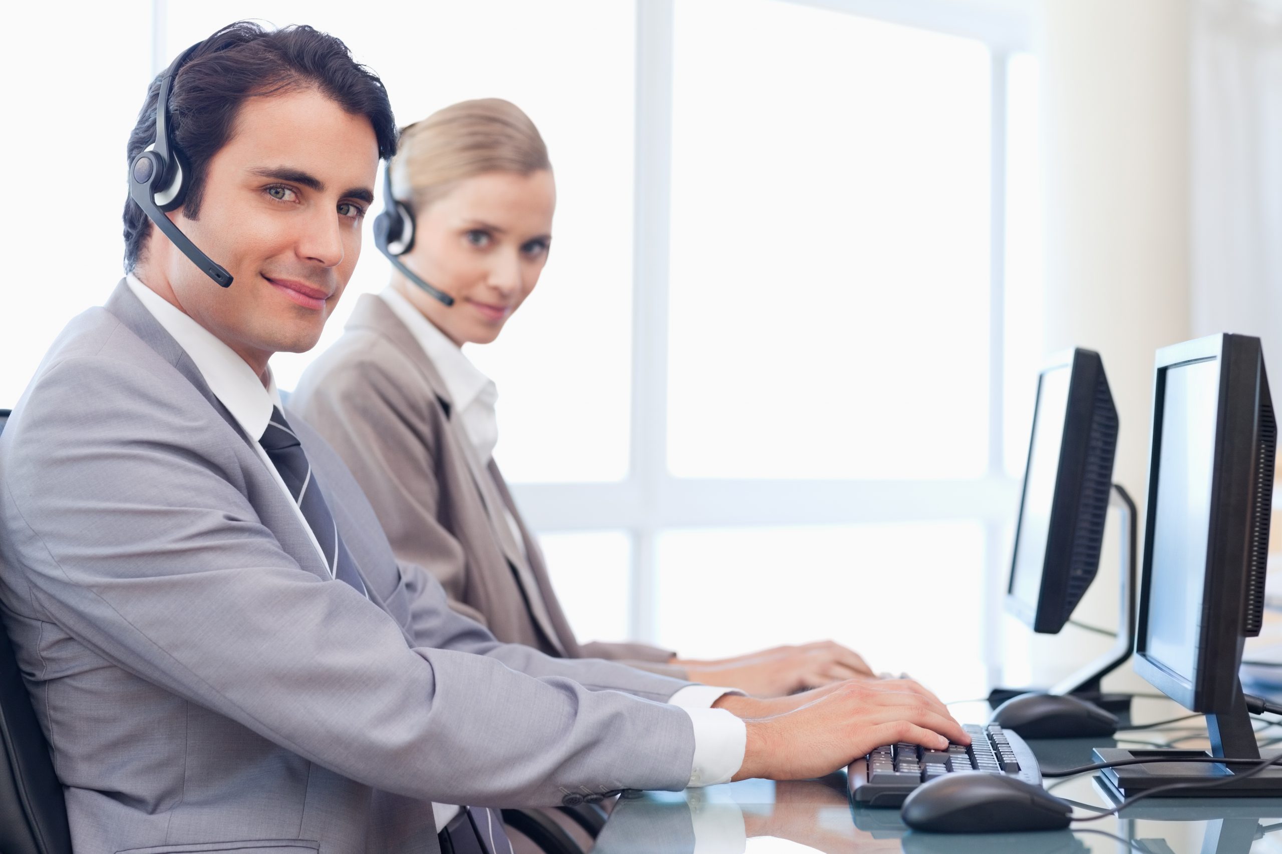 Operators using a monitor About AIS | Active Information Systems | Calgary | Information Technology Company